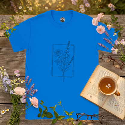 royal blue t-shirt on a picnic table surrounded by flowers, a book and a cup of tea