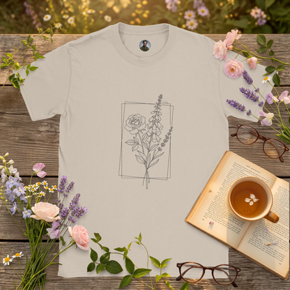 sand t-shirt on a picnic table surrounded by flowers, a book and a cup of tea