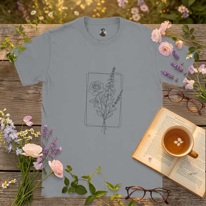 sport grey colour t-shirt on a picnic table surrounded by flowers, a book and a cup of tea