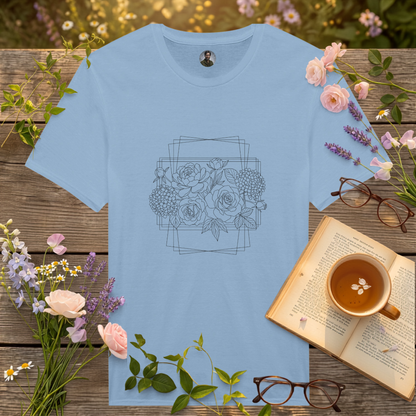 light blue coloured t-shirt on a picnic table surrounded by flowers, a book and a cup of tea