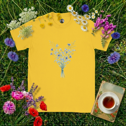 DAISY YELLOW COLOURED T-SHIRT ON GRASS SURROUNDED BY FLOWERS  , A BOOK AND A CUP OF TEA