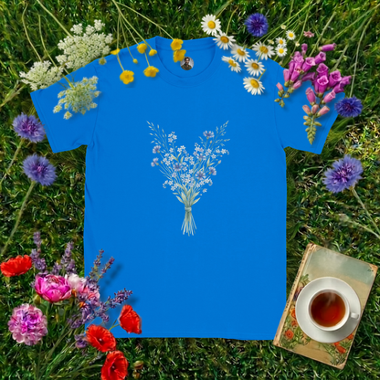 ROYAL BLUE COLOURED T-SHIRT ON GRASS SURROUNDED BY FLOWERS  , A BOOK AND A CUP OF TEA